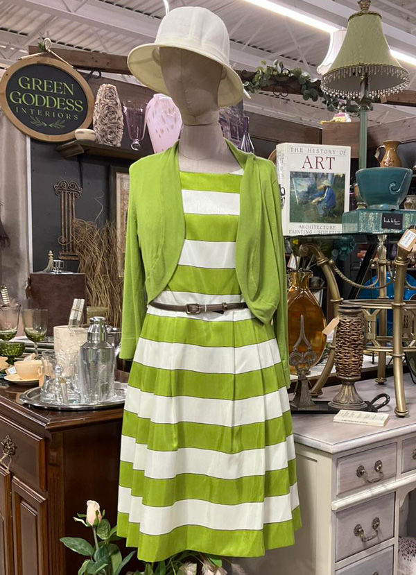 Mannequin wearing vintage green and white striped dress with cardigan and hat