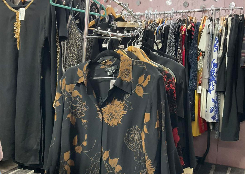Vintage clothing on display rack in vendor mall