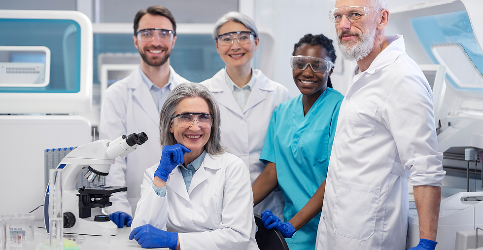 Smiling lab team in white coats
