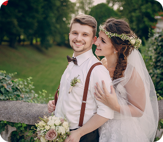 Happy bride and groom embracing outdoors