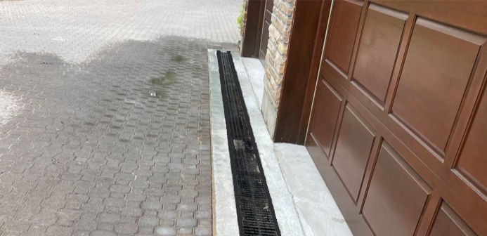 a linear drain in front of a residential driveway