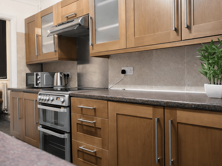 Modern fitted kitchen with oven, hob and storage in Beau Homes 3 bedroom student accommodation near Staffordshire University.