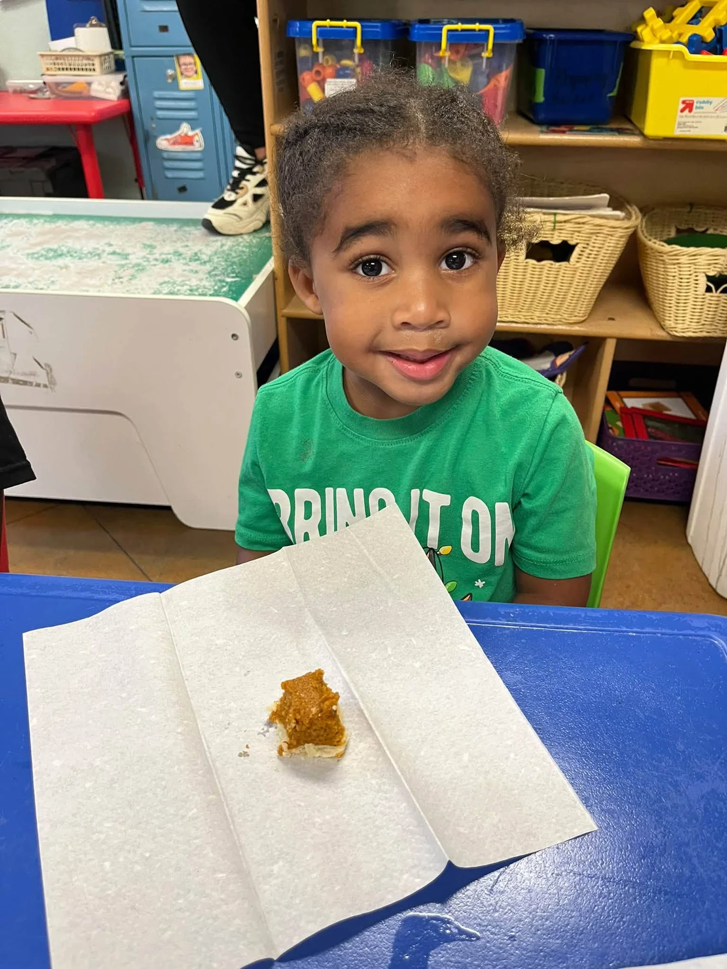 A smiling Pre-K child at the classroom table during the P is for Pumpkin Pie activity in September 2026