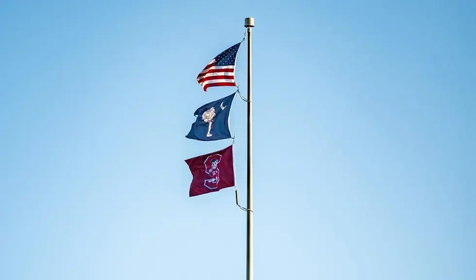 The South Carolina State University flag flies alongside the state and national flags on Statehouse grounds Monday, Jan. 19, 2026.