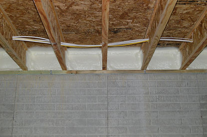 Closed-cell spray foam insulation in basement floor joists