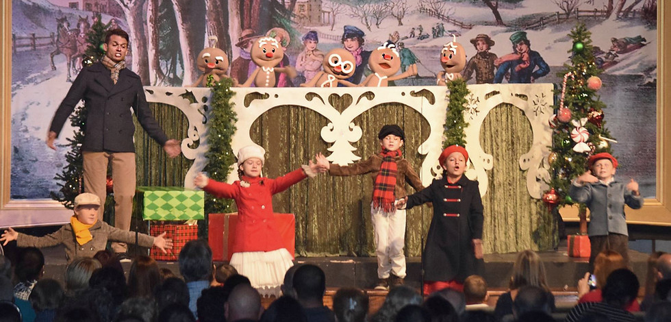 Brent performing at Christmas with children and the Gingerbrood characters