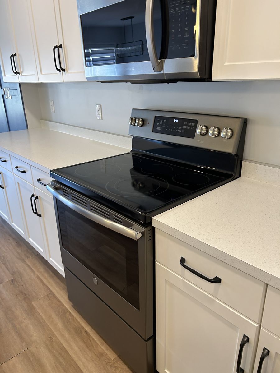 A clean glass-top stove and microwave