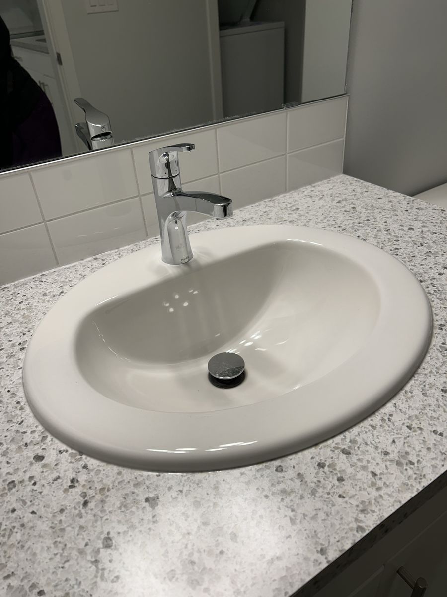 A clean white bathroom sink