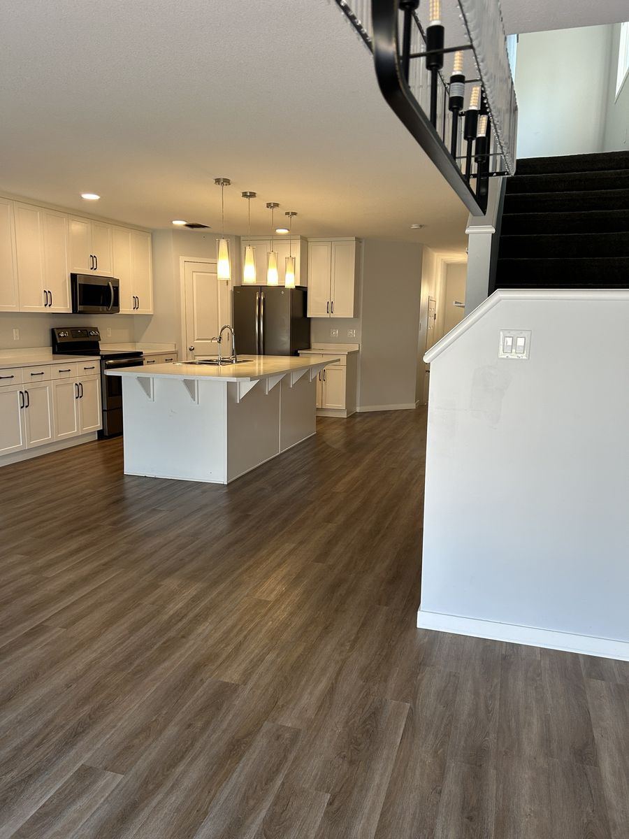 An open kitchen and living area with clean floors