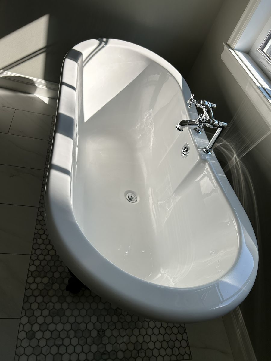 A freestanding bathtub, gleaming