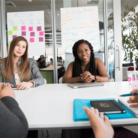 Frachise meeting across table making deals white desk
