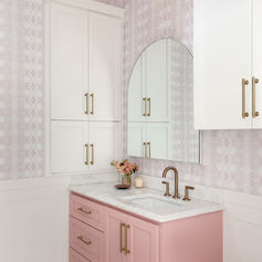 Pink Vanity Cabinet - Soft, pastel, charming.
White Marble Countertop - Smooth, veined, polished.
Brass Faucet Fixtures - Elegant, curved, metallic.
Patterned Wall Tile - Subtle, geometric, textured.
Arched Vanity Mirror - Frameless, curved, reflective.
White Upper Cabinets - Classic, shaker-style, spacious.
Hexagon Floor Tiles - Geometric, patterned, neutral.
Brass Drawer Pulls - Polished, sleek, cylindrical.
Decorative Wall Sconce - Globe, brass, multi-light.
Subtle Wallpaper Design - Soft, patterned, pastel.
Recessed Cabinet Handles - Modern, flush, brass.
Wainscoting Wall Panel - White, traditional, detailed.
Upper Cabinet Trim - Classic, crown, finished.
Brass Cabinet Hinges - Polished, hidden, sturdy.
Vanity Sink Basin - Undermount, white, ceramic.
Decorative Vase Accent - Small, floral, delicate.
Integrated Sink Backsplash - Seamless, marble, protective.
Subtle Wall Color - Warm, pastel, harmonious.
Floor Tile Grout Lines - Contrasting, thin, clean.
Decorative Lighting Fixture - Vintage, brass, focal.
