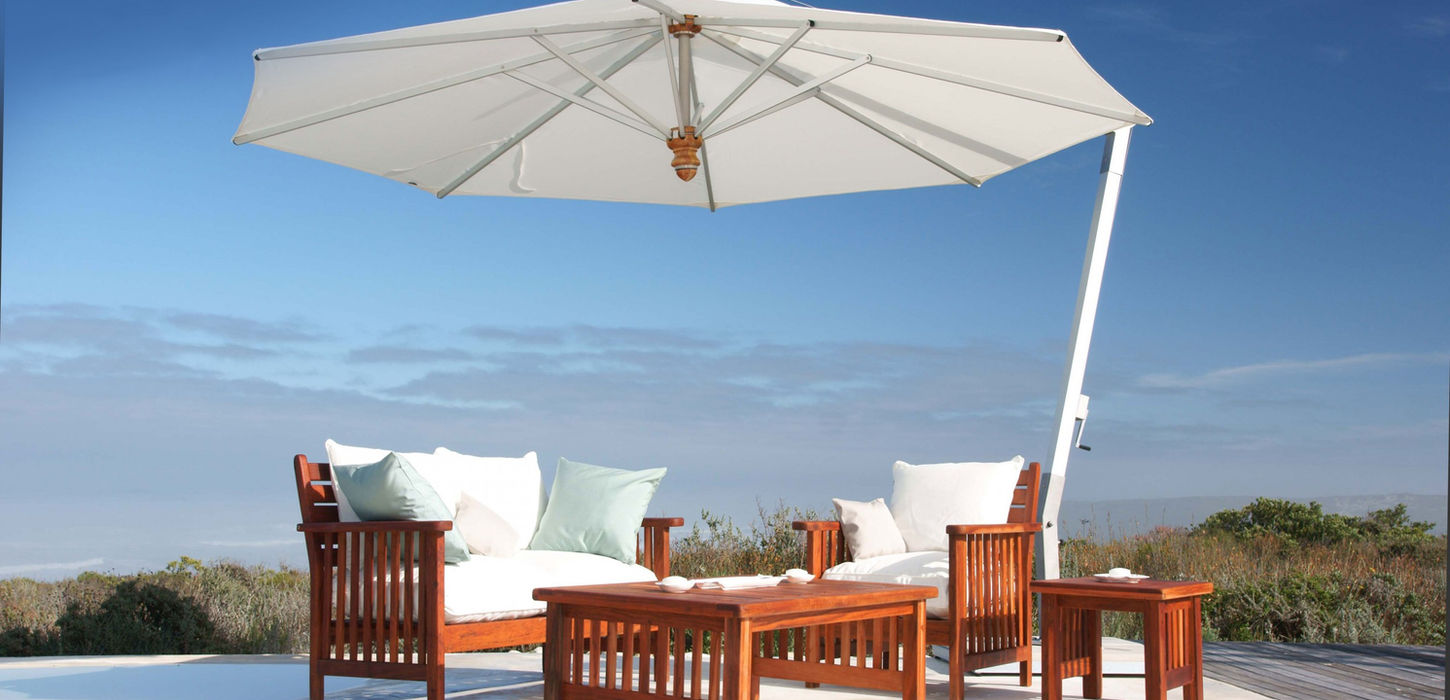 concrete patio with teak wood furniture and a sun umbrella