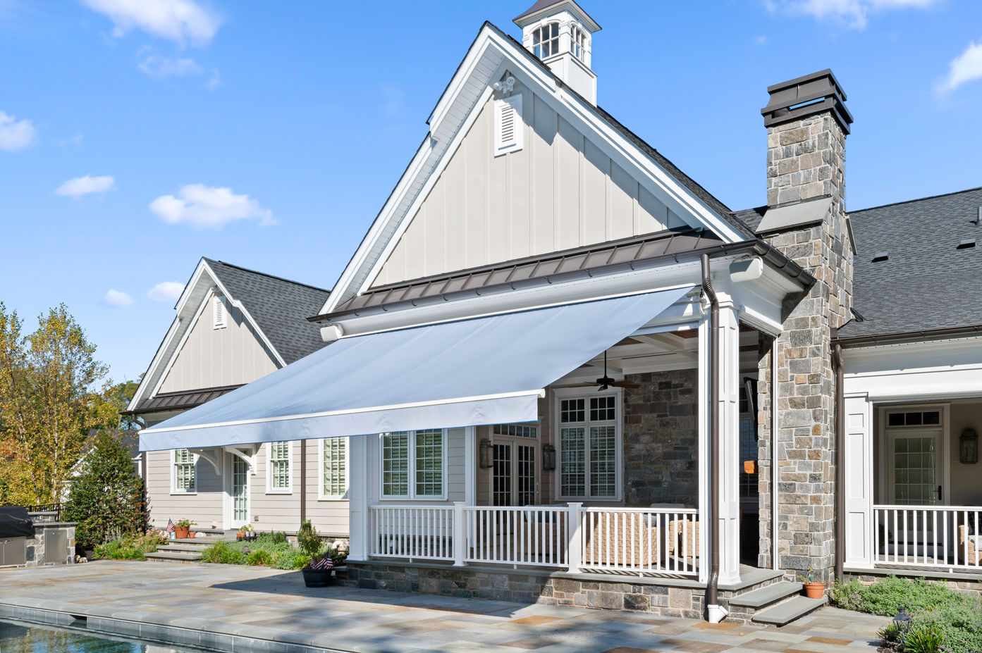 motorized awning extending over a front porch and walkway