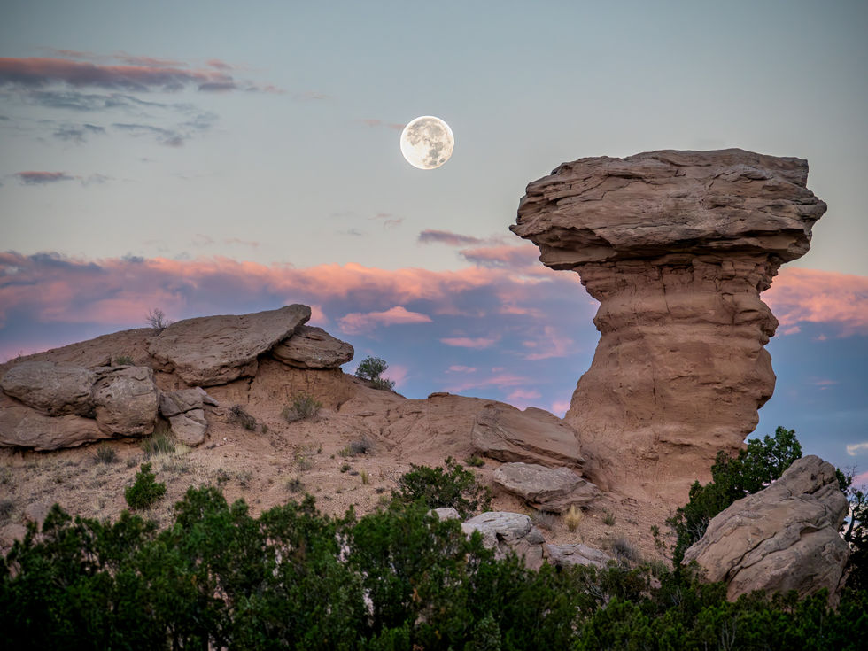 camel rock rock formation with a full moon on the background