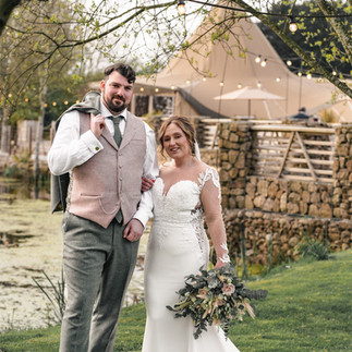 Happy wedding couple poses outdoors