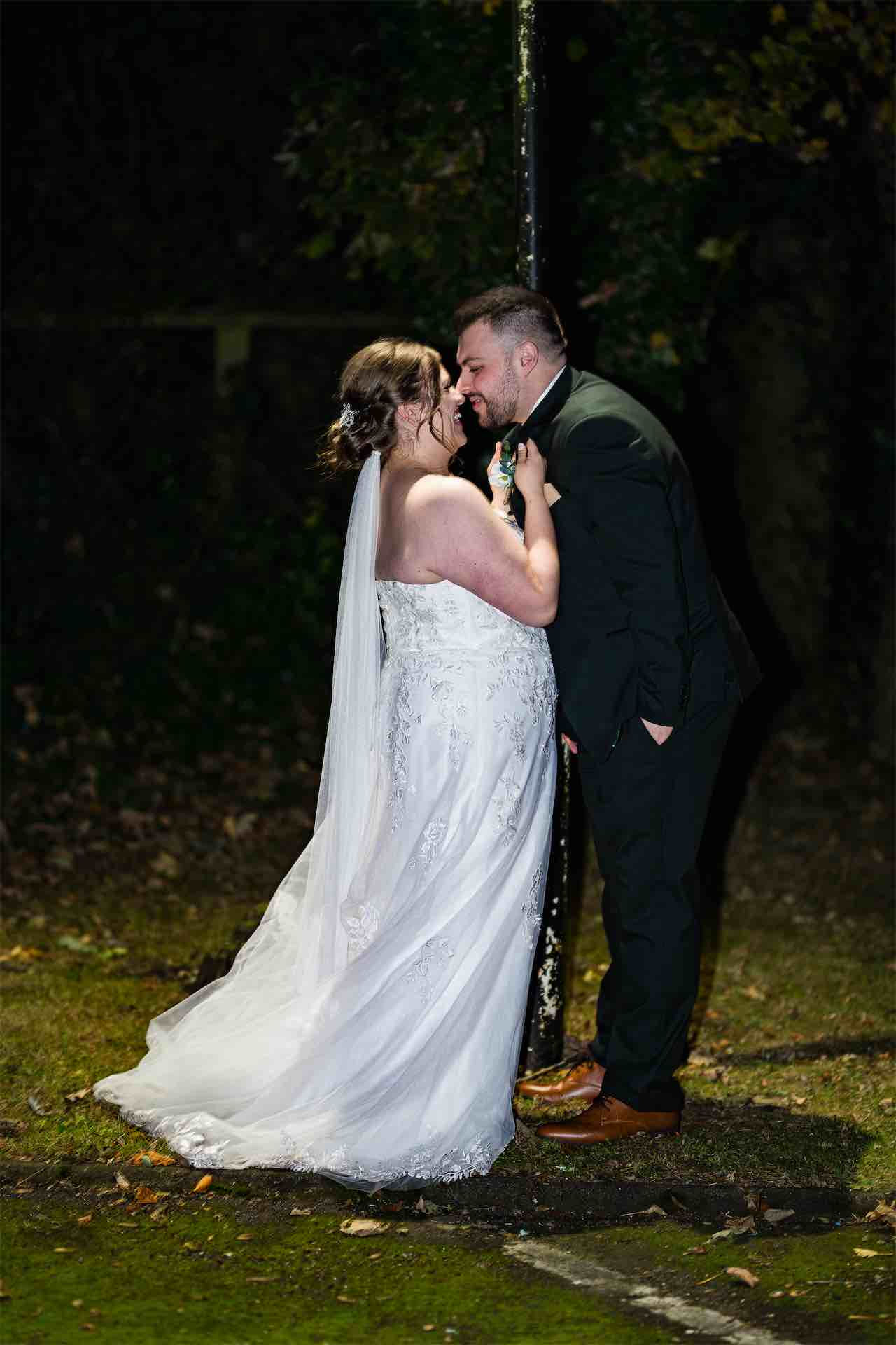 Bride and groom sharing a romantic moment at night