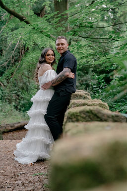 Happy couple poses for LUX Wedding Photos in a lush forest