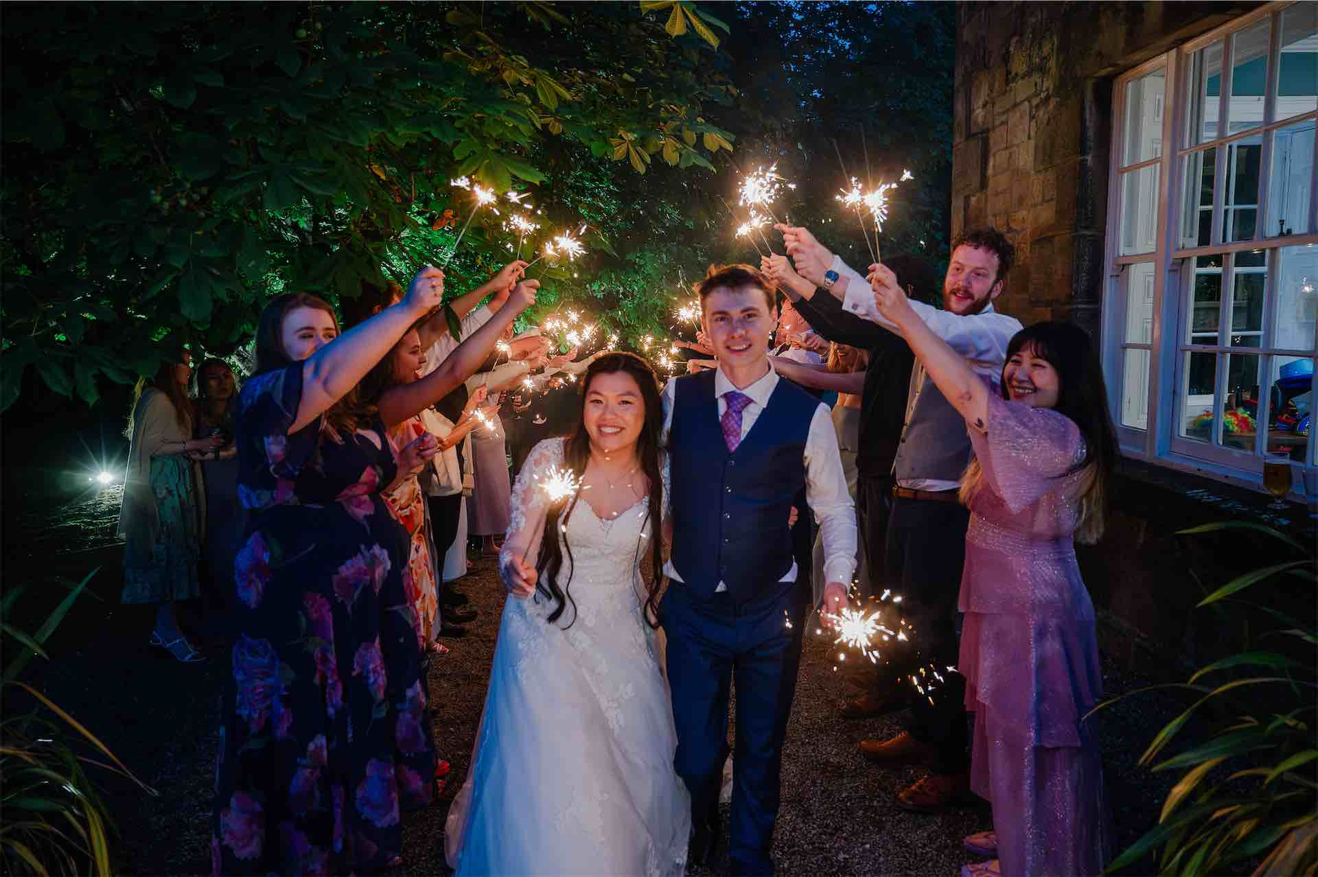 Bride and groom exit wedding with sparklers wedding photographers in the north east
