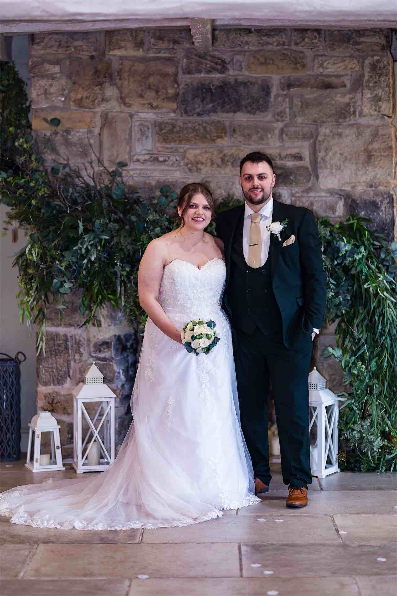 Happy couple poses for wedding photo at South Causey Inn