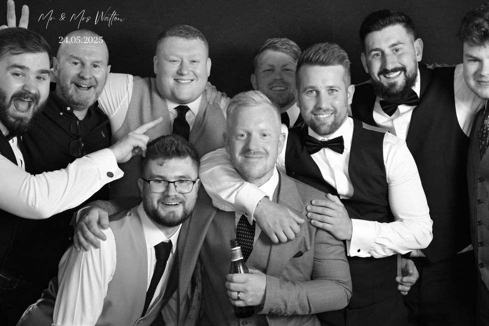 Group of men in suits, smiling, at event