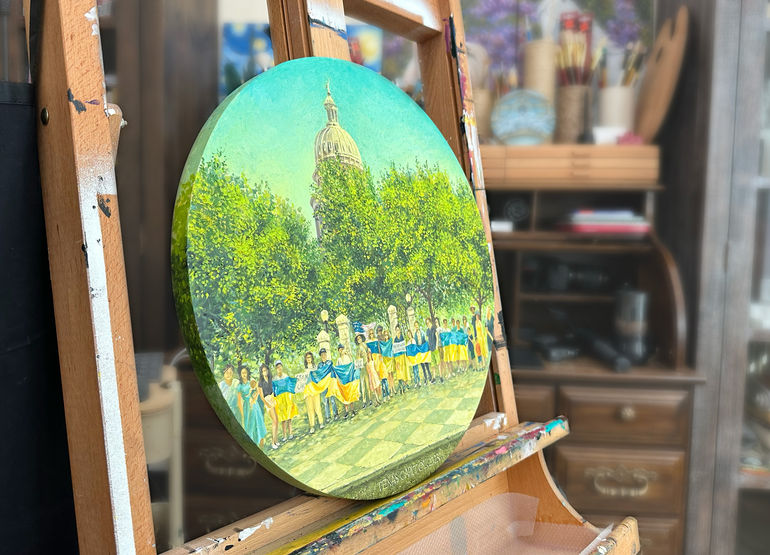 Side view of tondo oil painting Keep it weekly by Catherine Snowstorm on a studio easel. Highlights the 1-inch depth of the round wooden panel.