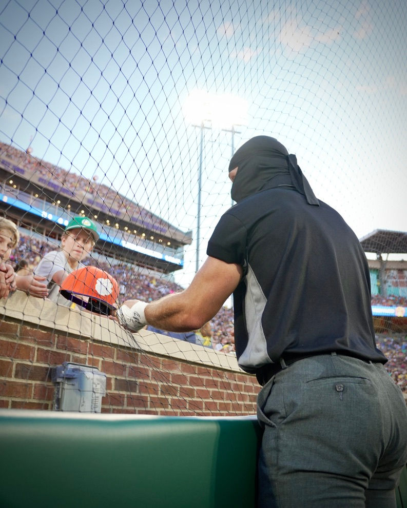 Umpire Ninja, Baseball Ninja Seth Markham interacts with fans in the stands during a Savannah Bananas baseball game