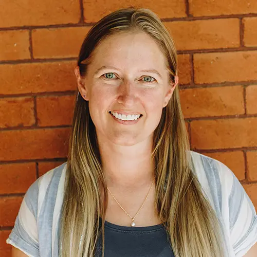 Testimonial portrait of Vanessa McCrann, Managing Director at Startup Colorado praising SmithBorn Studio brand design.