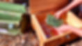 A person opens the escape game box and examines its contents outdoors
