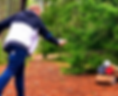 A participant throws an axe at the center of the target in an axe-throwing competition.