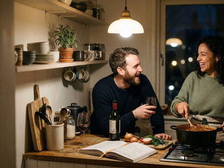 Couple cooking together in kitchen laughing and bonding over shared activity