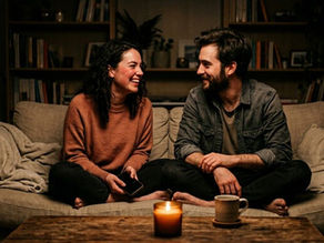 Couple sitting casually on couch smiling and chatting comfortably without deep or meaningful questions