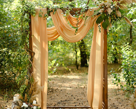 Yellow wedding arch in forest. Concept of decorations and ceremony outdoor place..jpg