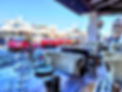 Luxurious cars and yachts parked in front of the El Gaucho de Banús restaurant in the front line of Puerto Banús MArbella
