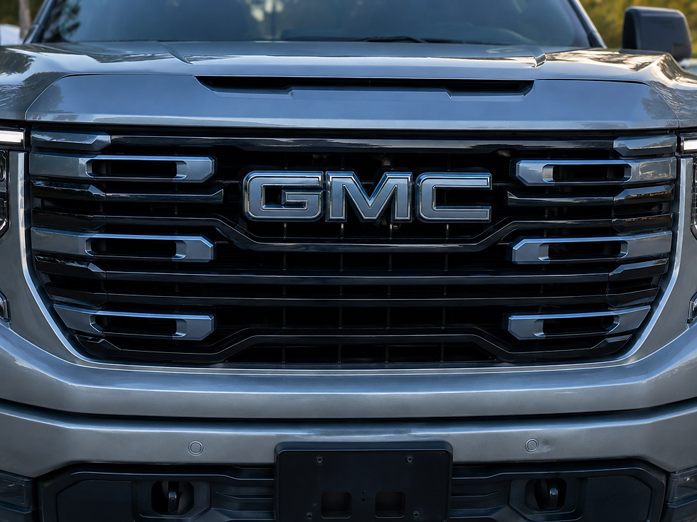 Painted front GMC grille emblem installed on a 2019–2026 GMC Sierra