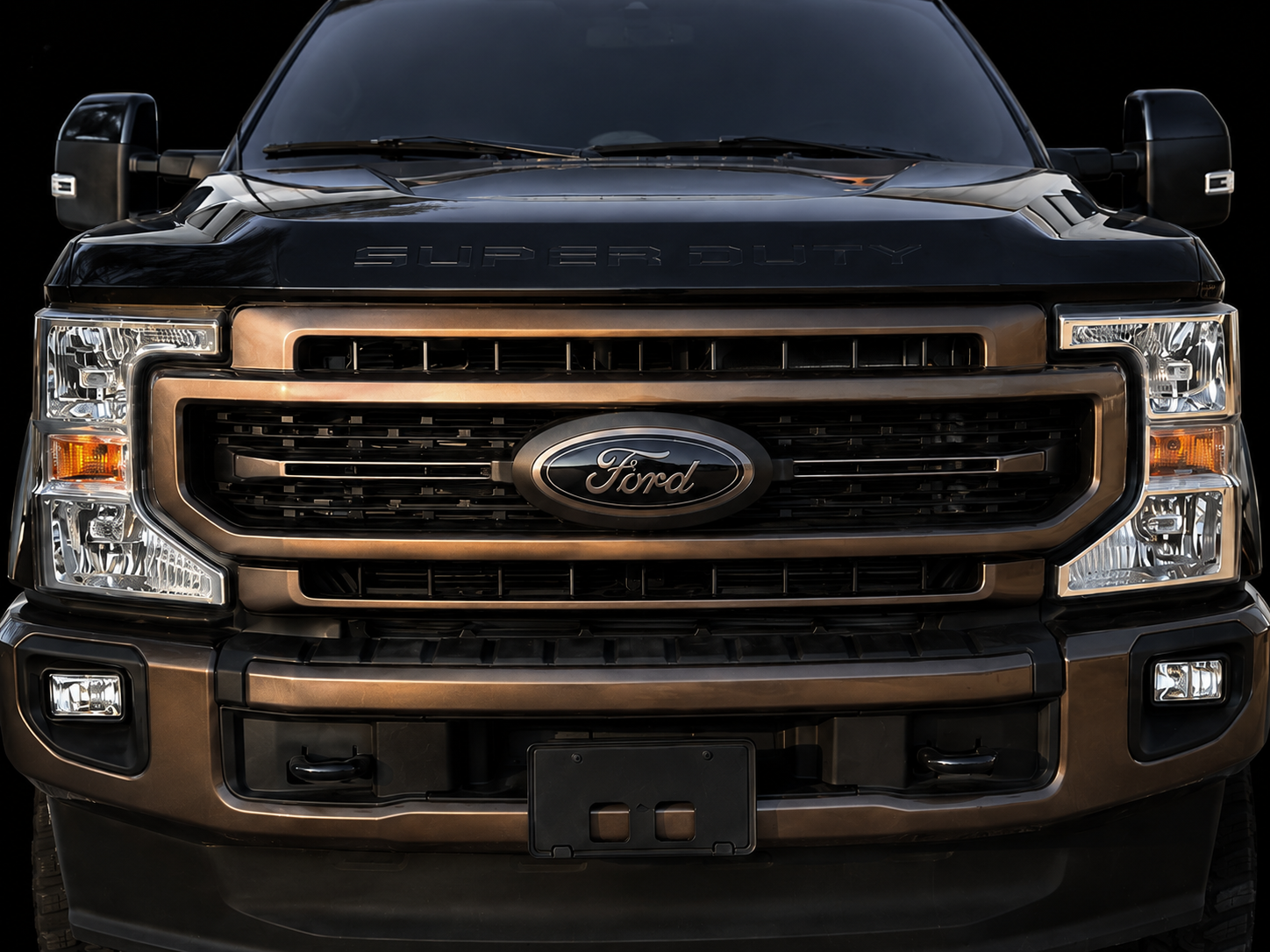 Black and bronze painted front Ford oval emblem on a Super Duty truck