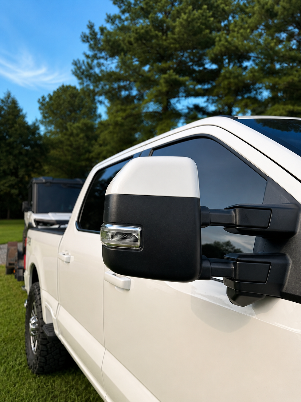 Color-matched Ford tow mirror caps installed on a white Super Duty truck