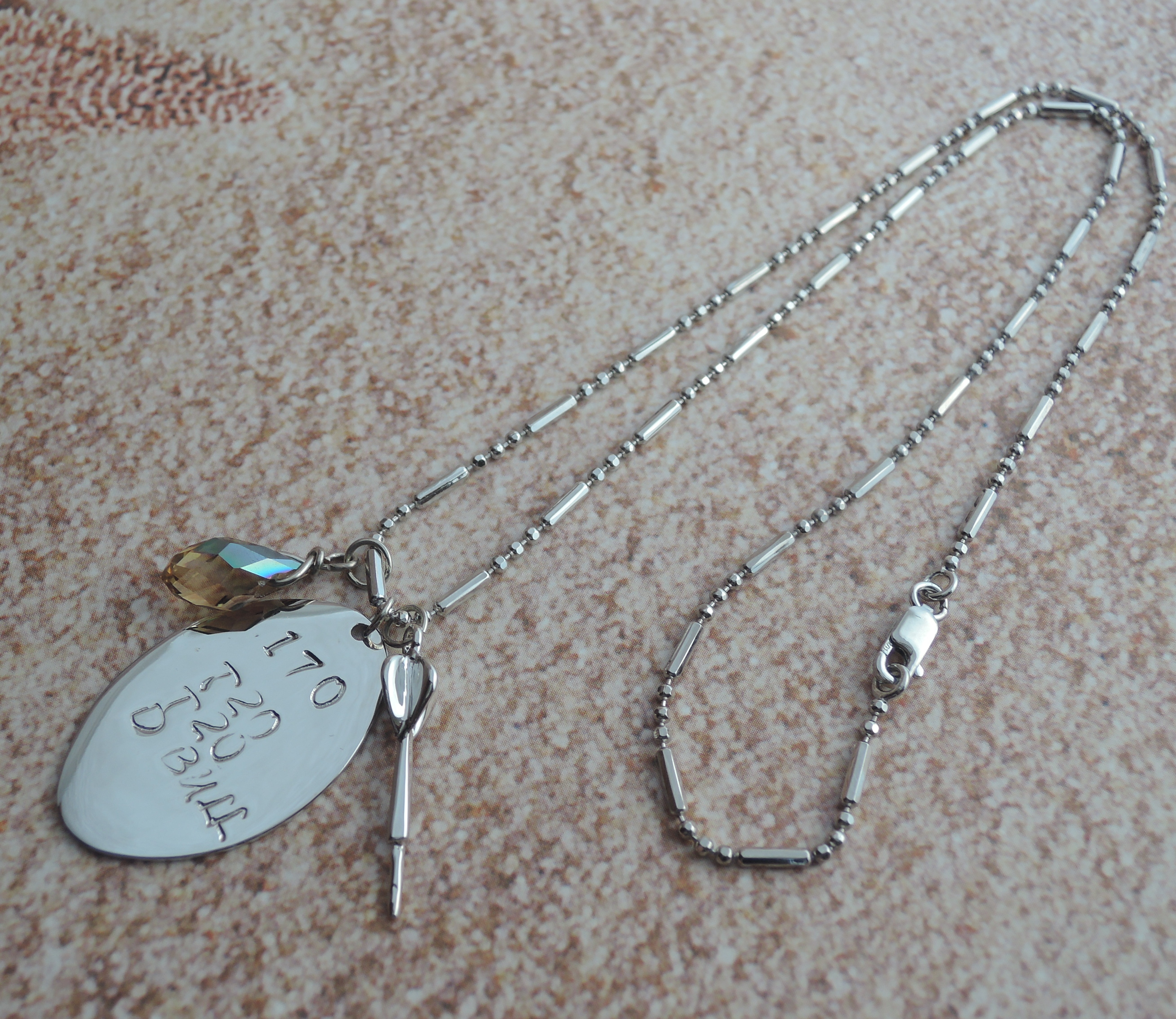 Rhodium plated hand stamped oval dis