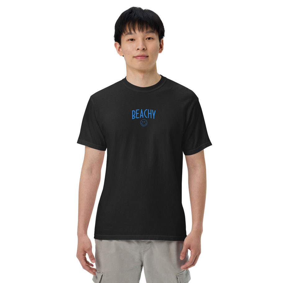 Black heavyweight Comfort Colors graphic tee with a minimalist blue beachy smile typography embroidery design centered on the