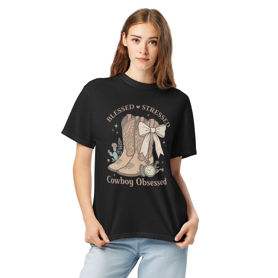 “Blessed Stressed Cowboy Obsessed graphic t-shirt in vintage black, featuring a detailed illustration of cowboy boots with a