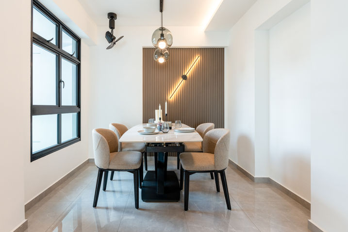 Dining table with timber-slat feature wall and diagonal lighting at Waterfront II @ Northshore