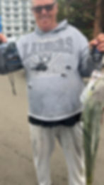 travis weighing his kingfish and entering it into competition