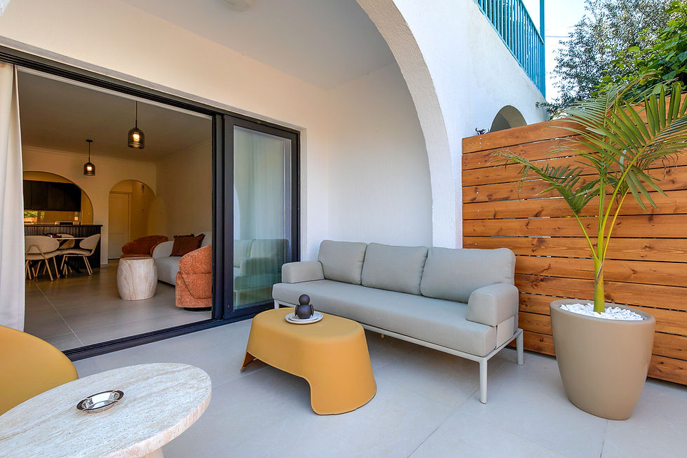 Modern beachfront villa with minimalist architecture, turquoise sea views, and palm trees beside the water.