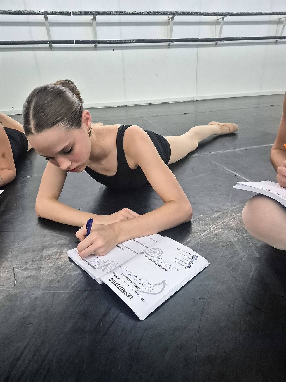 dancer writing in a dance journal