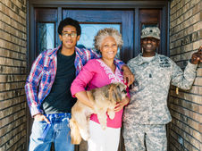 a family of three people with the center woman holding a dog