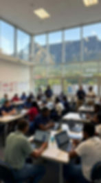 "Diverse group of adult learners in a Cape Town training classroom with Table Mountain view"