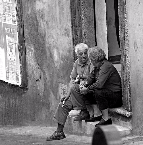 Two older men chatting, discussing how they can call or text Rob Philion on evenings and weekends.