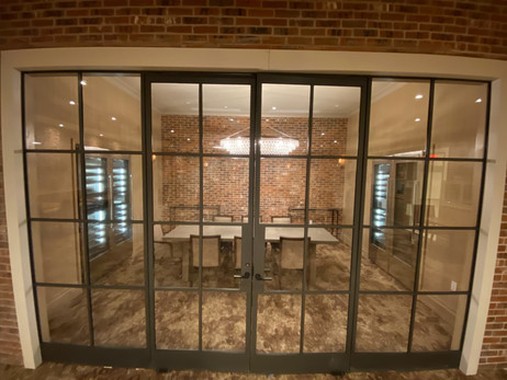 a room with a table and chairs and a brick wall