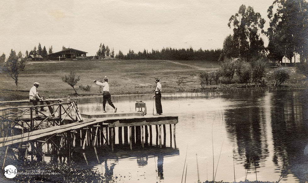 Three men playing golf over "The Splash Hole" at Recreation Park, with the first Virginia Country Club building in the background, undated.