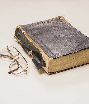 Worn leather bound Bible with reading glasses.jpg
